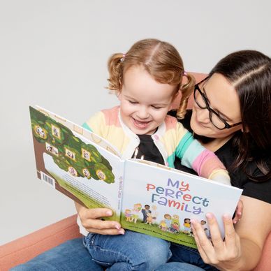 mother and daughter reading a donor conception book