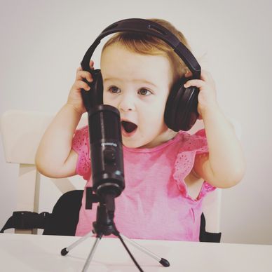 Toddler shocked in a podcast recording with headphones and microphone