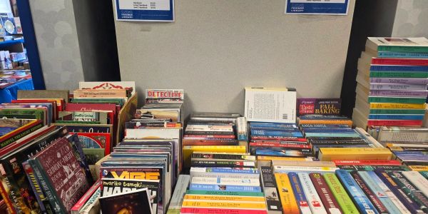A table filled with various CDs and DVDs.