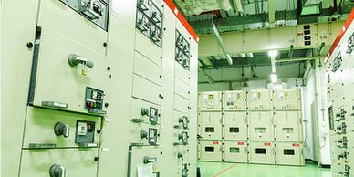 A clean electrical control room with panels and switches.