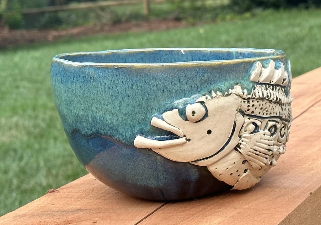 Big Bass Bowl. Hand-built belly bowl with a relief, large mouth bass design over a blue variation gl