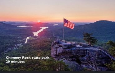 Sunset view at Chimney Rock State Park with an American flag on a rock.