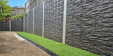 Dark Slate Concrete Sleeper Retaining Wall and Dark Colorbond Fence