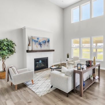 Modern living room with fireplace and large windows.