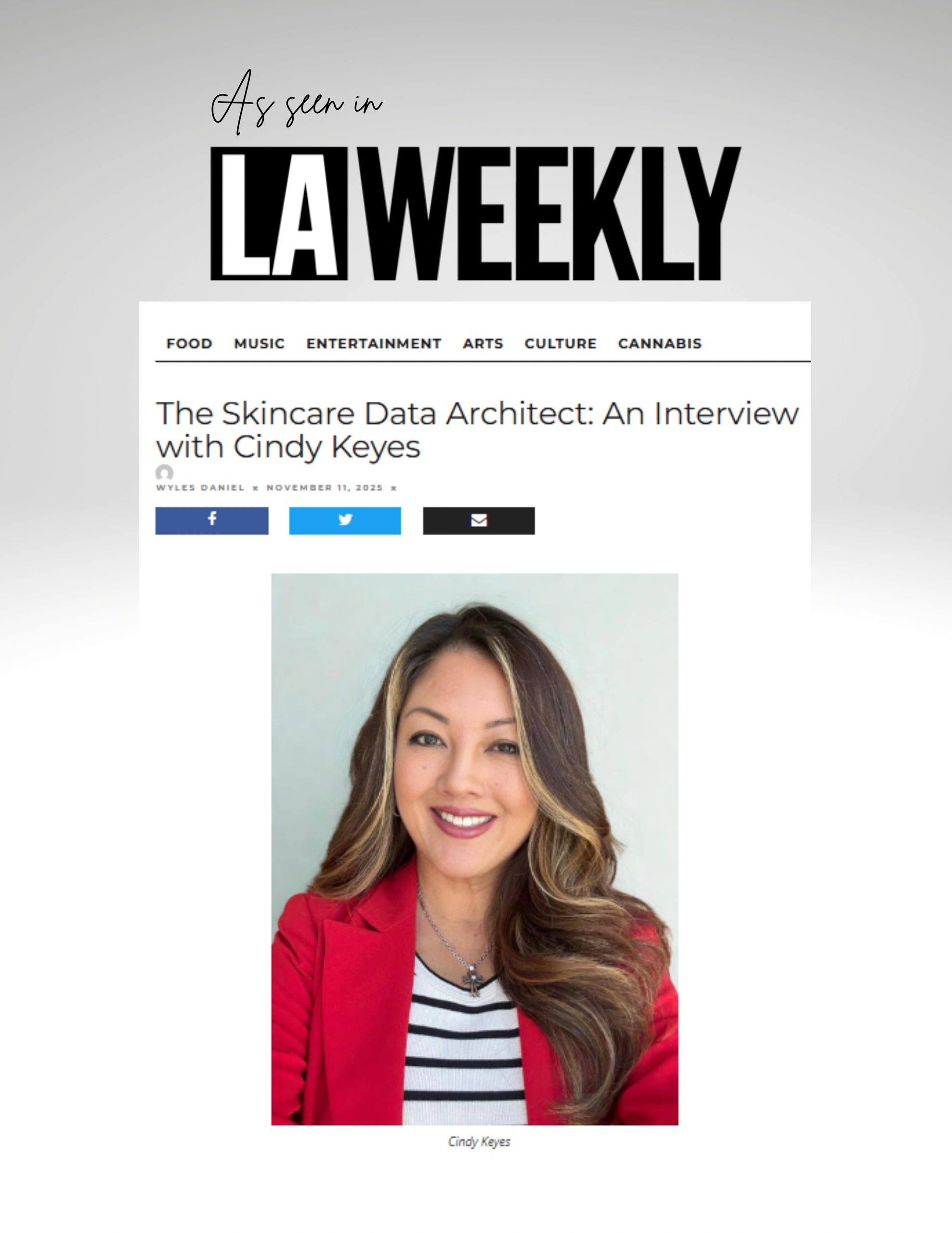 woman with brown hair in a red blazer and white and black striped tank top
