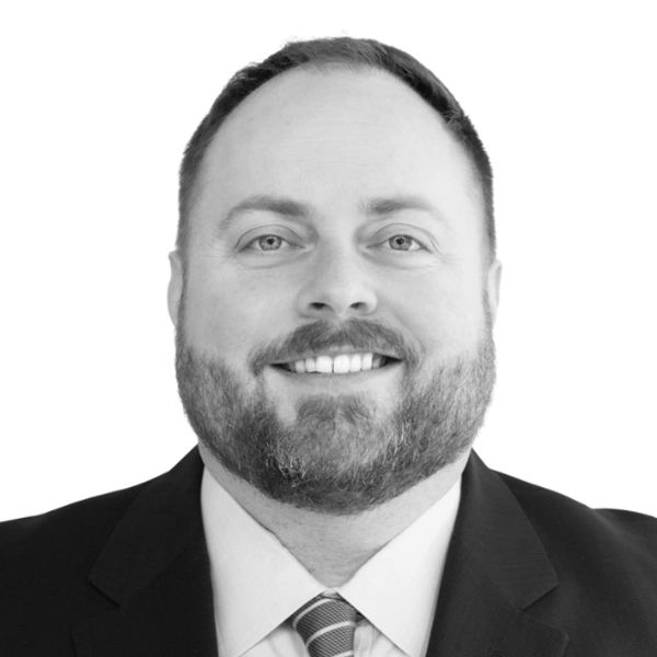 black and white photo of a male in a suit