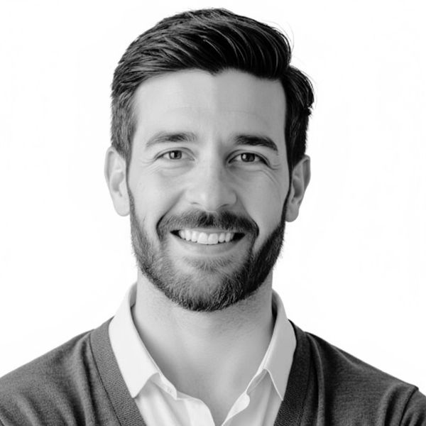 Black and white headshot of a male smiling