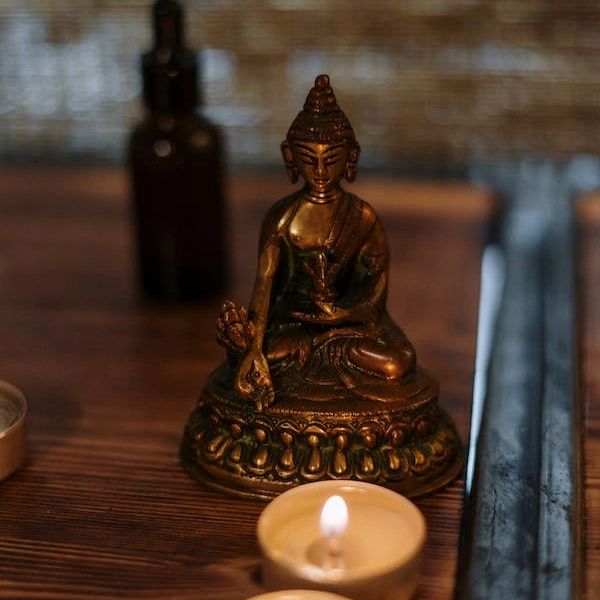 The Medicine Buddha statue and candles 