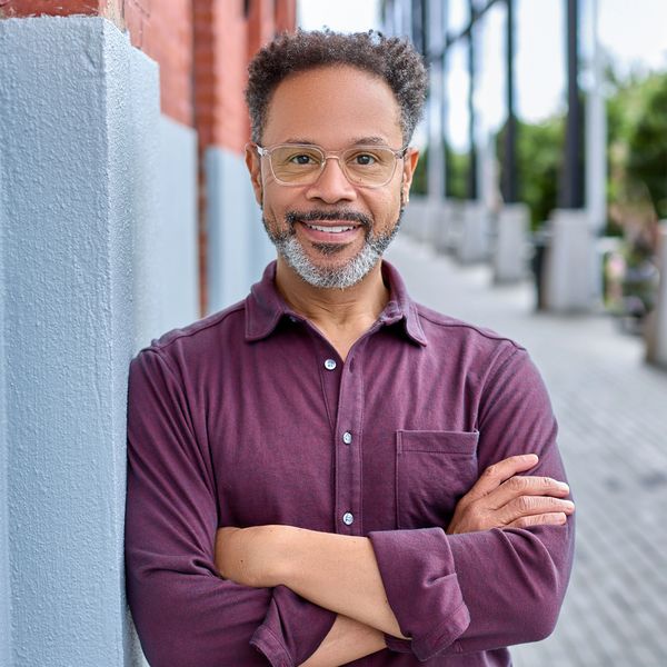 headshot of a man in purple shirt 