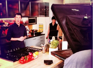 Teleprompter operator on set with Bobby Flay