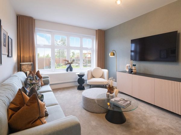 Contemporary new build living room with large bay window, neutral décor, and wall-mounted TV.