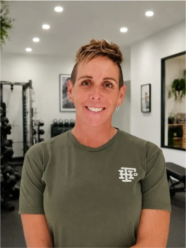 Smiling person in a gym setting.