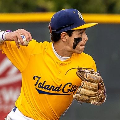 Baseball player in yellow Island City uniform pitching.
