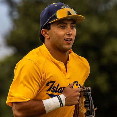 Baseball player in yellow Island City jersey.