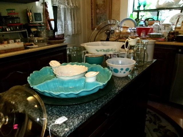 Vintage kitchenware and glassware on a granite countertop.
