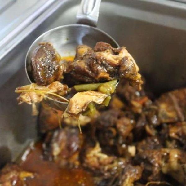 Scoop of Fresh Jamaican oxtail ready to serve at Vybz Kitchen in Martinsburg WV


