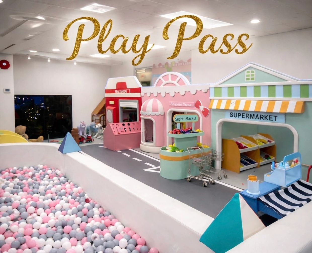 Indoor kids play area with ball pit and mini town setup.