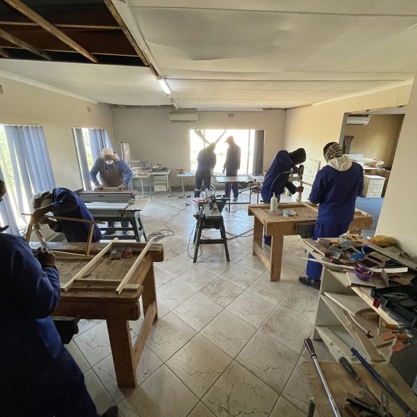 Workshop with people working on wood projects.