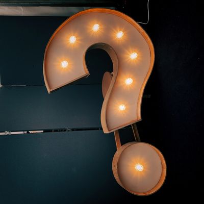 Question mark light sign symbolizing junk removal FAQs and customer questions