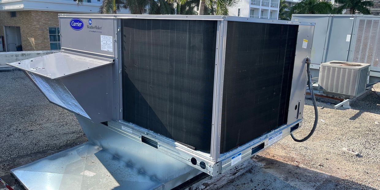 Large Carrier WeatherMaker rooftop HVAC unit on a building roof.