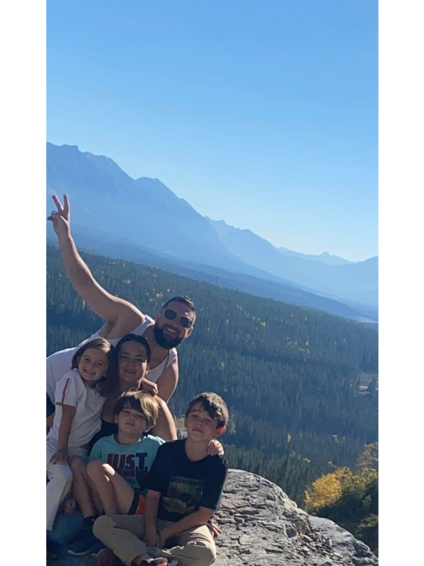 Tanya and family on a mountain climb, view of the valley