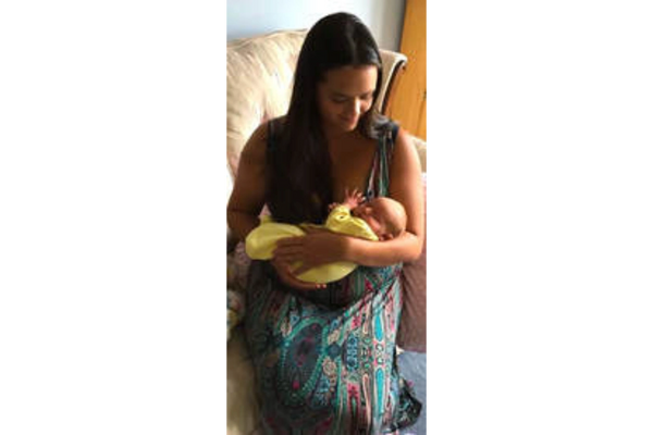 Tanya birth doula and baby in a yellow onesie