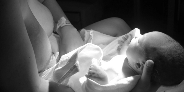 Angelic light filled picture of a newborn baby and mother