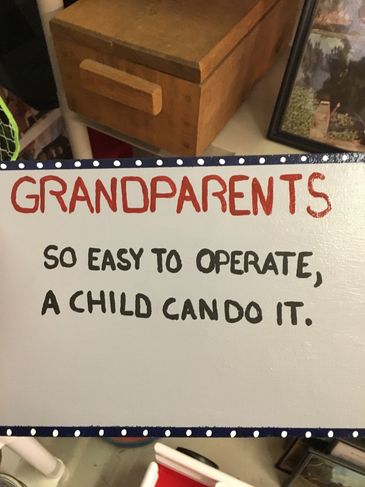 A humorous sign about grandparents being easy to operate.