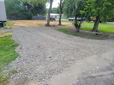 Gravel driveway or service road in a wooded area.