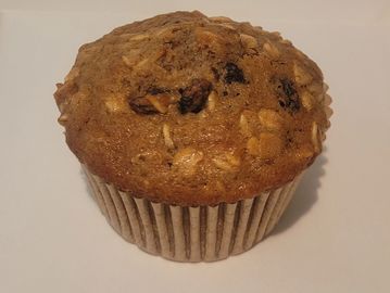 Oatmeal raisin muffin on a white background.