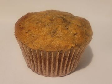 A single chocolate chip muffin on a white surface.