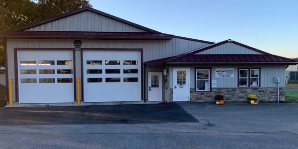 A small fire station building with two large garage doors and an entrance.