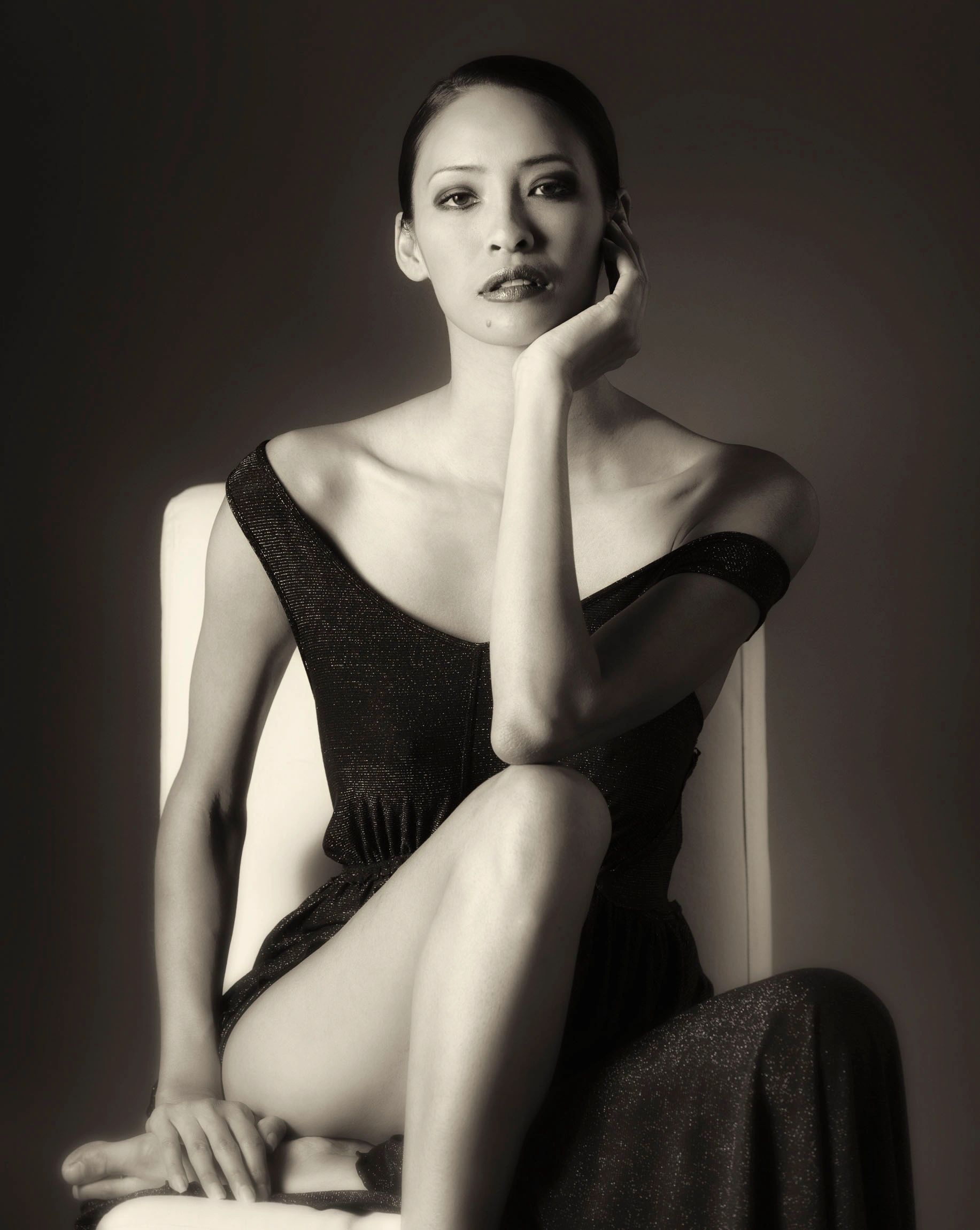 Black and white portrait of a woman in an elegant pose.