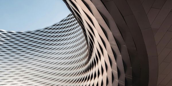 Curved modern architectural structure with repeating patterns.