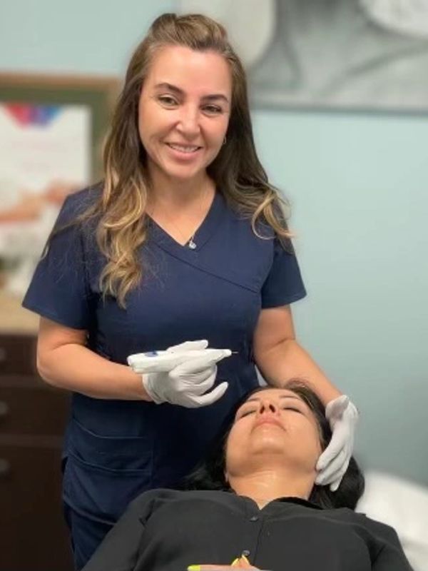 A healthcare professional prepares to administer a cosmetic injection to a patient.
