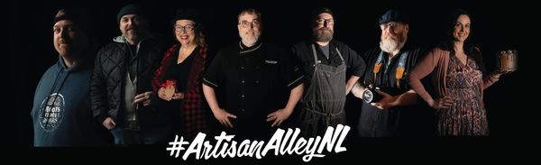 Group of artisans posing with their crafts against a dark background.