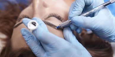 Lady having semi permanent make up using a Microblade to create hair strokes onto her eyebrows.