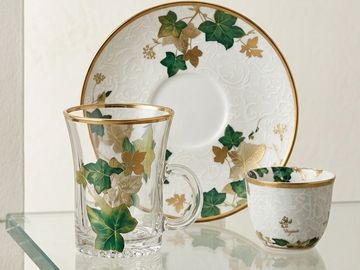 Elegant glass and porcelain cup set with green and gold ivy design.