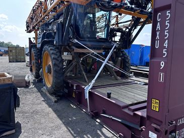 Large agricultural machinery loaded onto a flatbed trailer for transport.