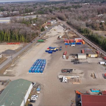 Aerial view of an industrial yard with containers and trucks.