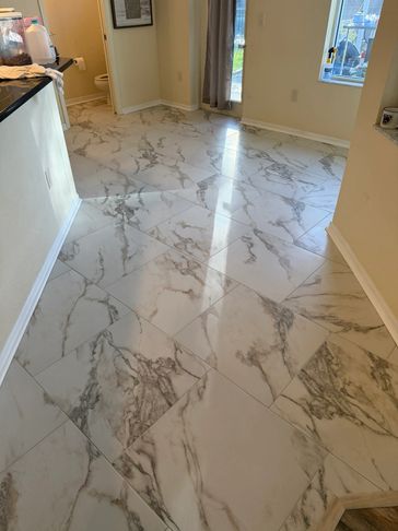 Room with polished marble-look tiles and neutral walls.