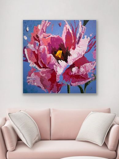 Abstract pink flower painting above a blush sofa with white pillows.
