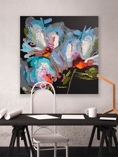 Abstract floral painting above a modern desk setup with chair and lamp.