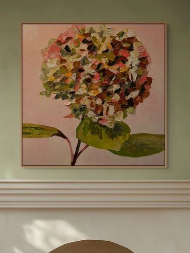 Abstract floral painting with textured petals in warm tones on a muted wall.