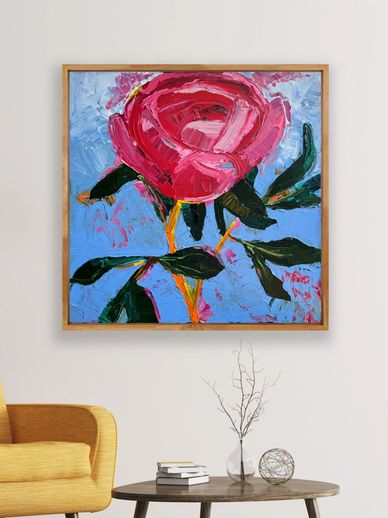Bold red rose painting in a wooden frame above a modern living room setup.