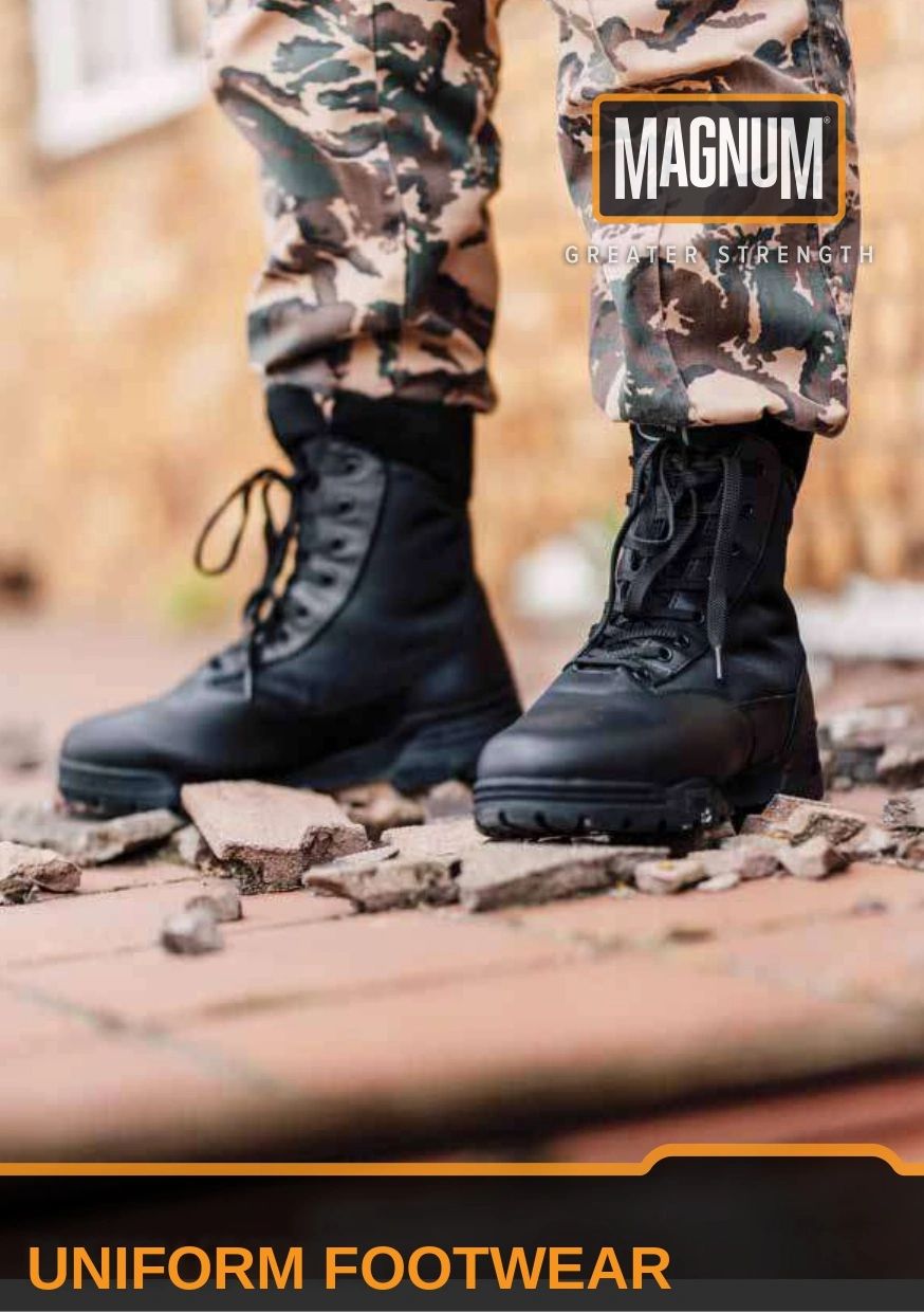 Black tactical boots worn with camouflage pants on rough ground.