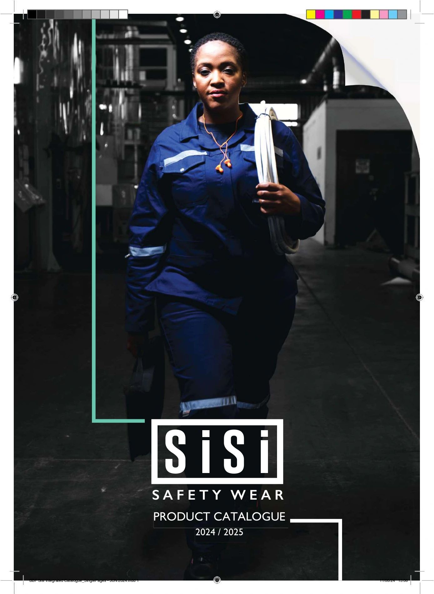 Woman in safety wear walking confidently in an industrial setting.