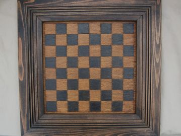 Wooden chessboard with a rustic frame.