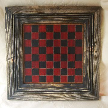 Wooden checkerboard with red and black squares.