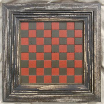 Wooden framed checkerboard with red and black squares.